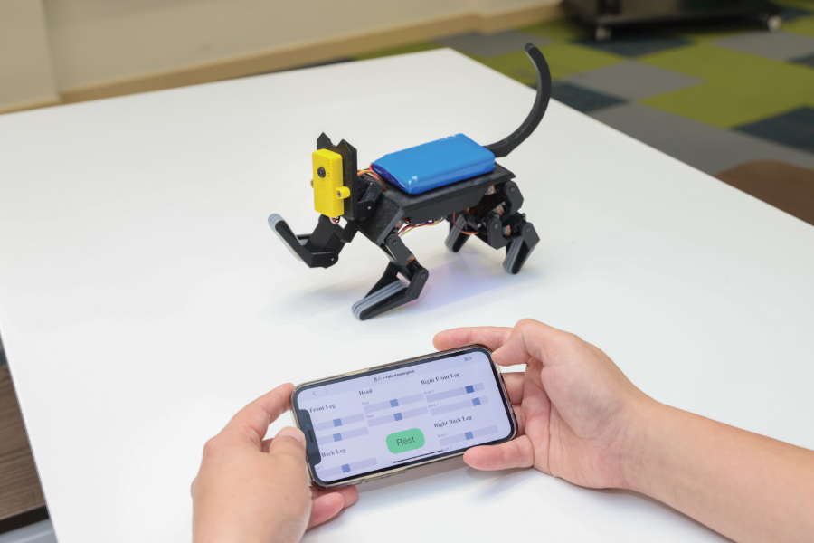 Made by 3D printing, the robotic cat poses gestures of standing, nodding its head and wagging its tail with mobile installation.