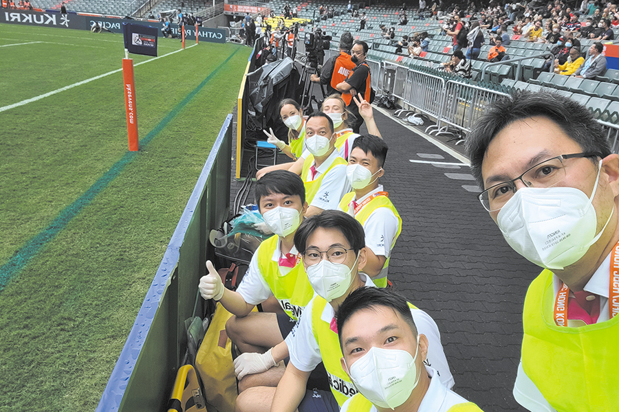 Dr Chau (right) now trains younger doctors to work as MDDs at sporting events.