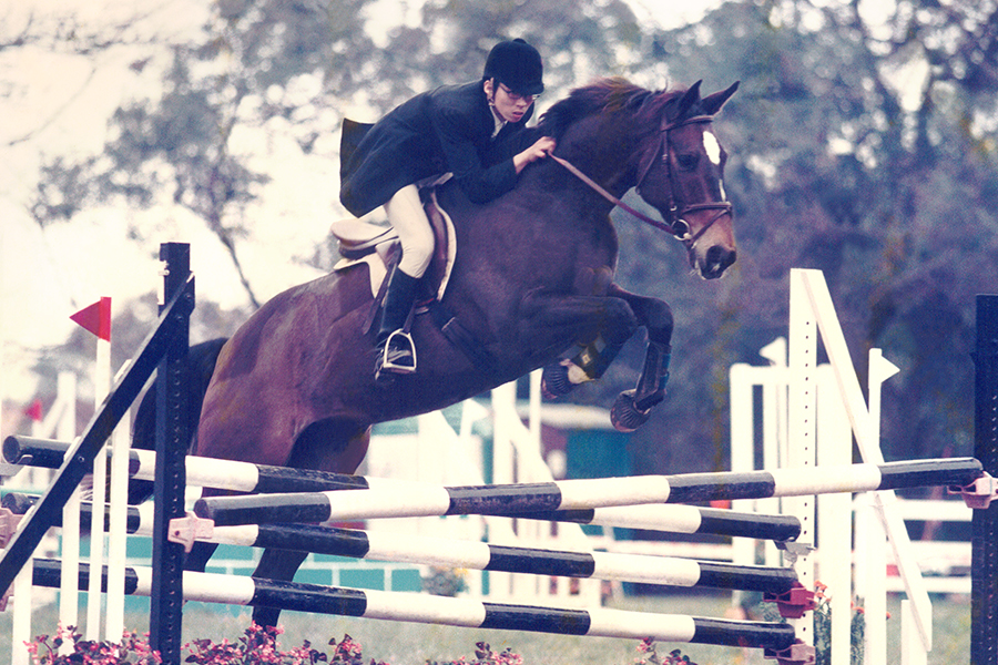 A young Danny shows his skills at show jumping.
