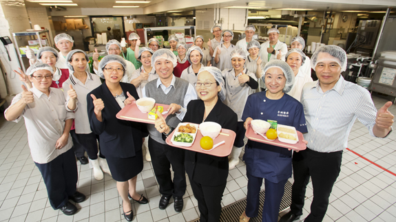 Clara (front row, third from right) and her team are committed to providing healthy meals to patients.